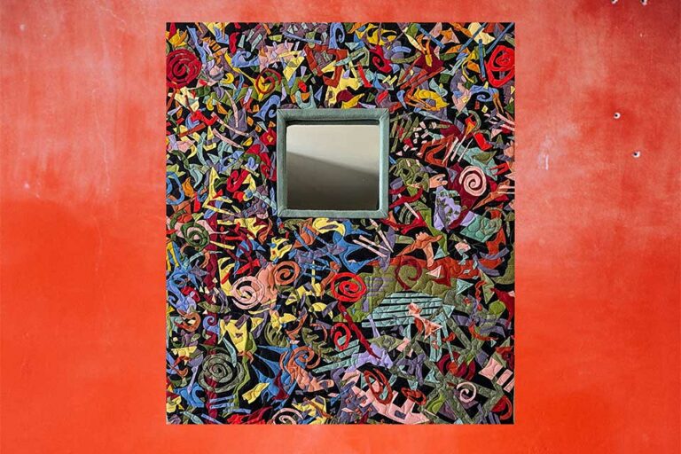 Abex mirror hanging on a red wall