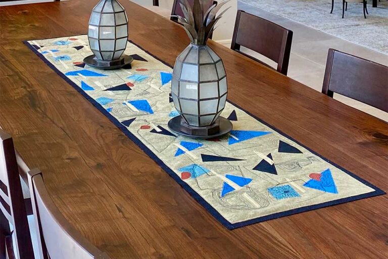 Quirky Digs table runner on dark wood table